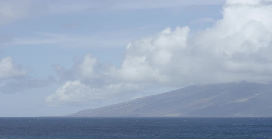An ocean with a mountain range in the distance