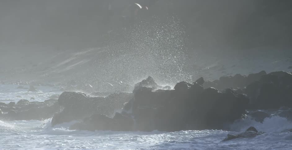 Waves crashing up against a rocky shore