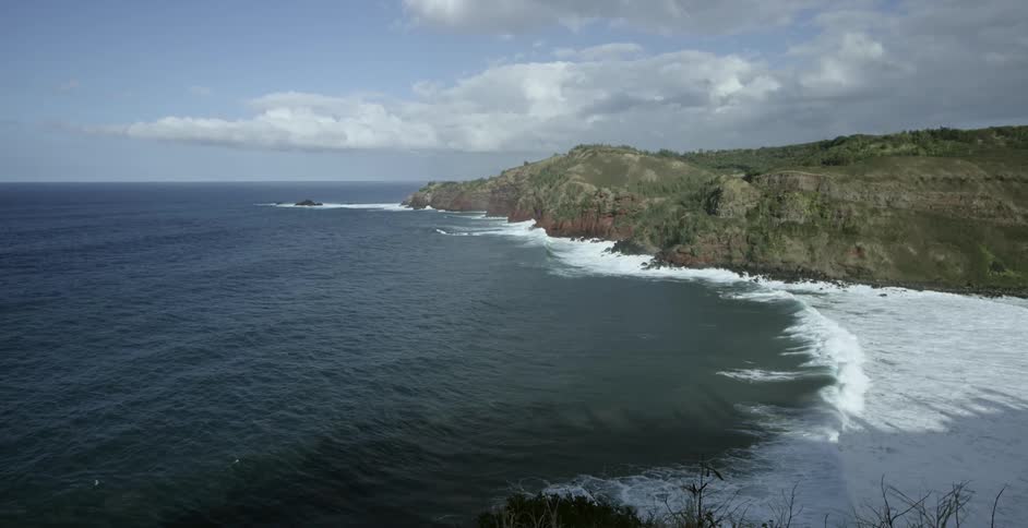 Waves move to a shoreline dominated by steep cliffs