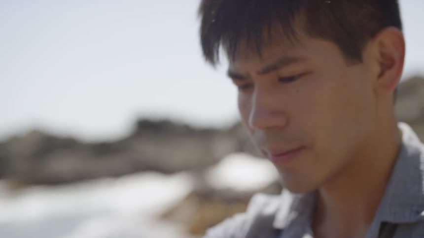 A man looks toward his musical instrument