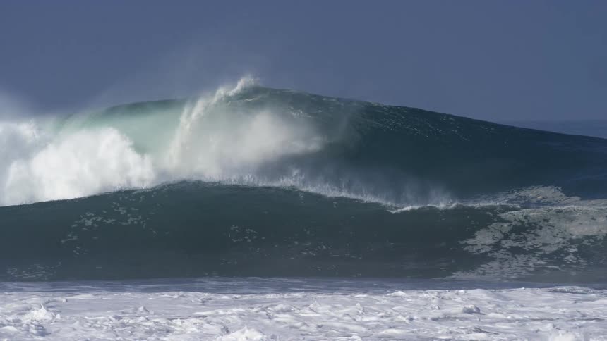 Large waves crash towards the shore