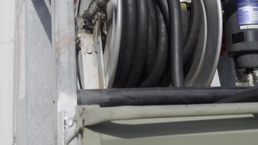 A hose being rolled off of a spool