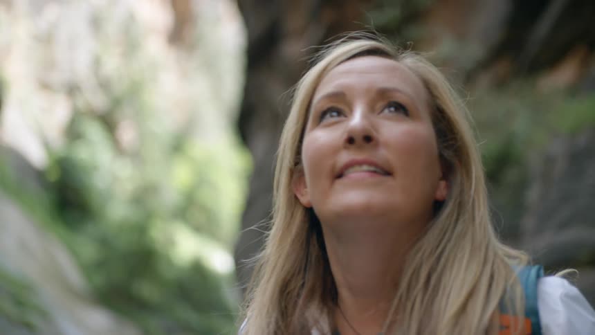 A woman looks at her surroundings and smiles