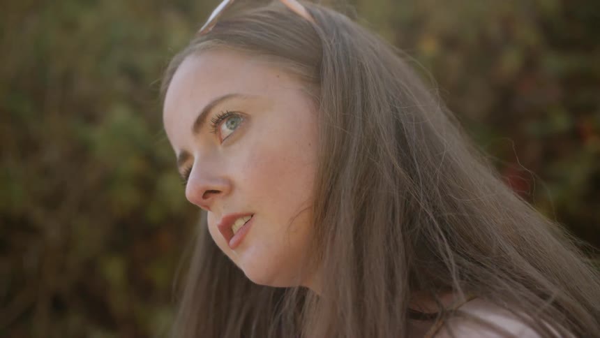 Woman looks sideways in the forest