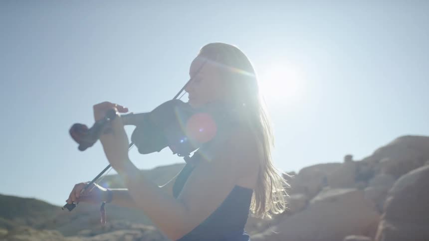 A woman plays the fiddle