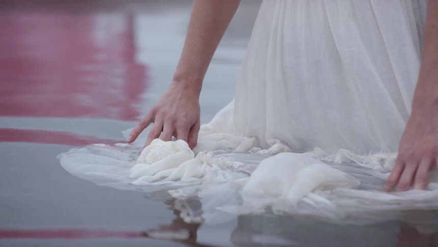 A woman stands in the water