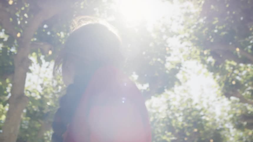A woman stands in the trees