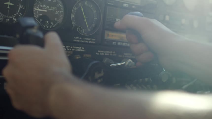 A man turning the controls on an airplane