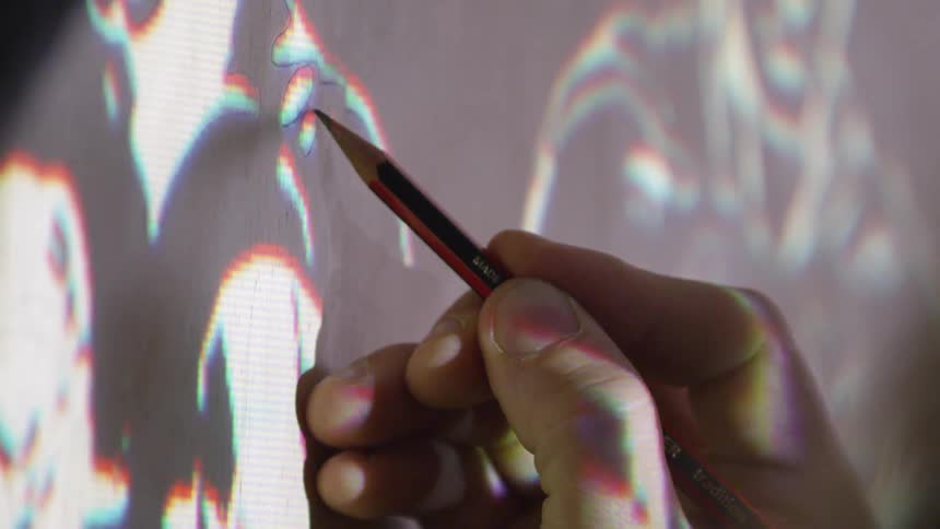 Someone tracing a projected image