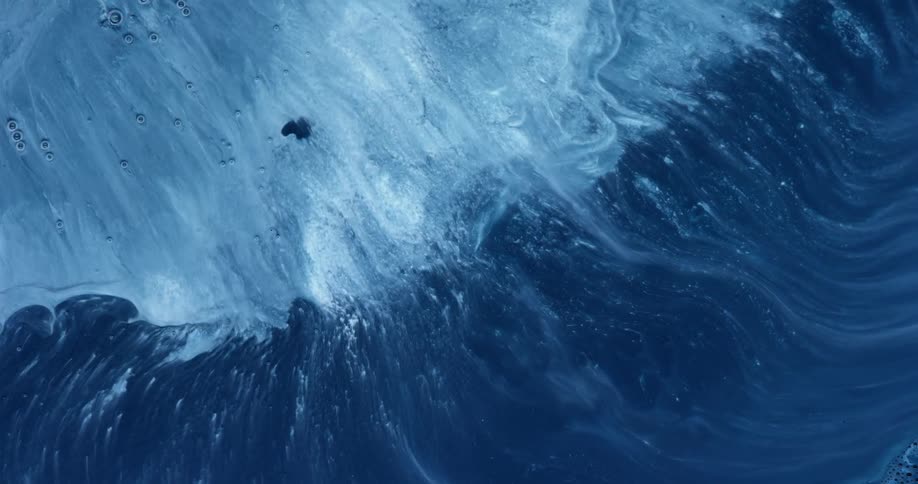 A light blue viscous liquid gradually mixes with a darker blue liquid