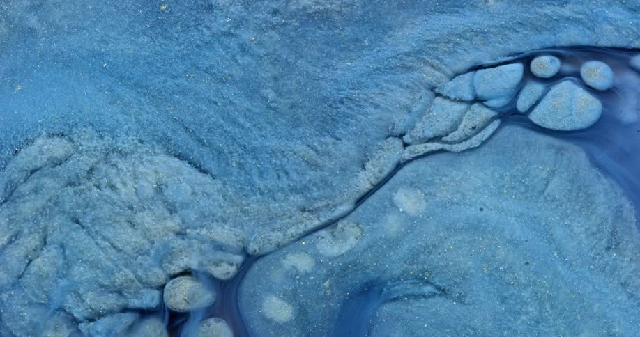 Bright blue liquid and ricks swirled together