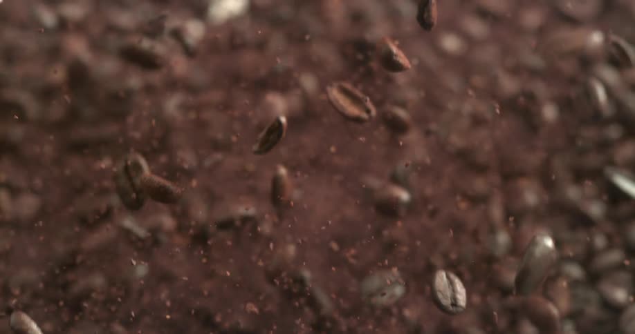 Coffee beans and grounds shaking in the air