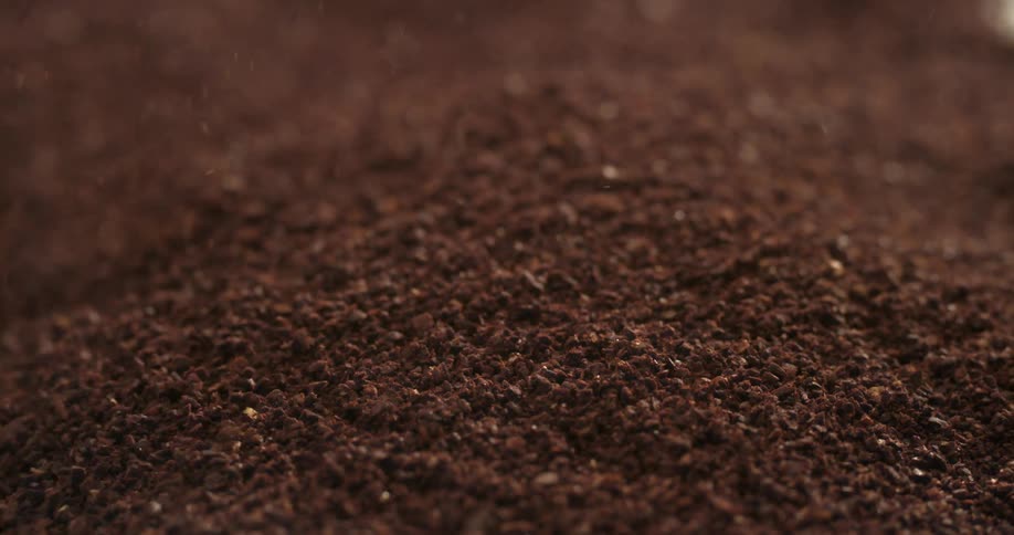 Coffee grounds falling into pile, slow motion