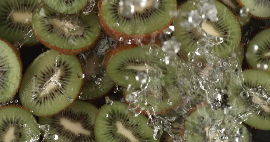Kiwi slices being splashed with water