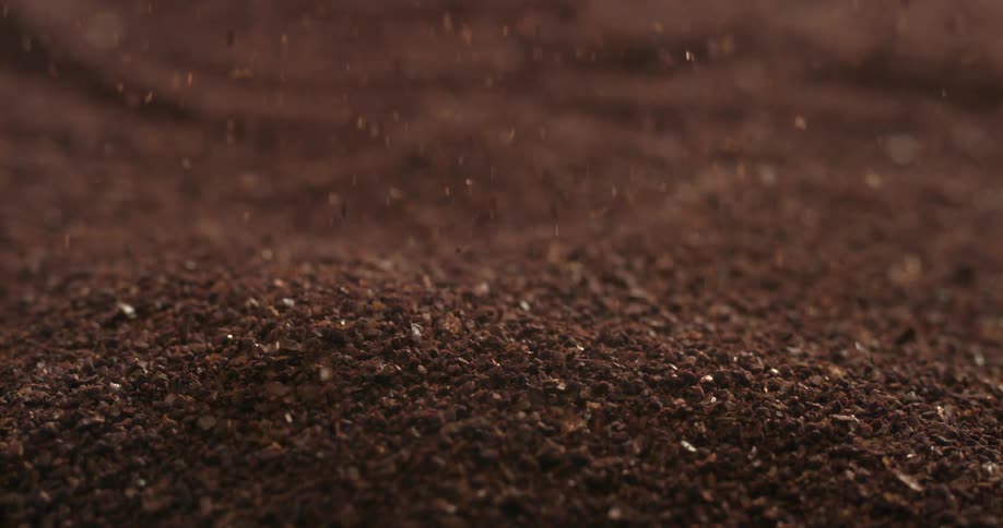 Ground coffee falling in slow motion