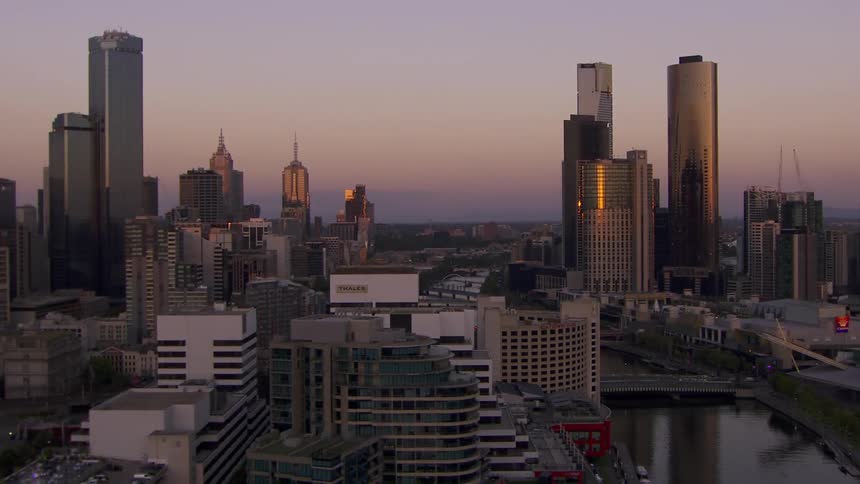 A city skyline glistens as the sun sets