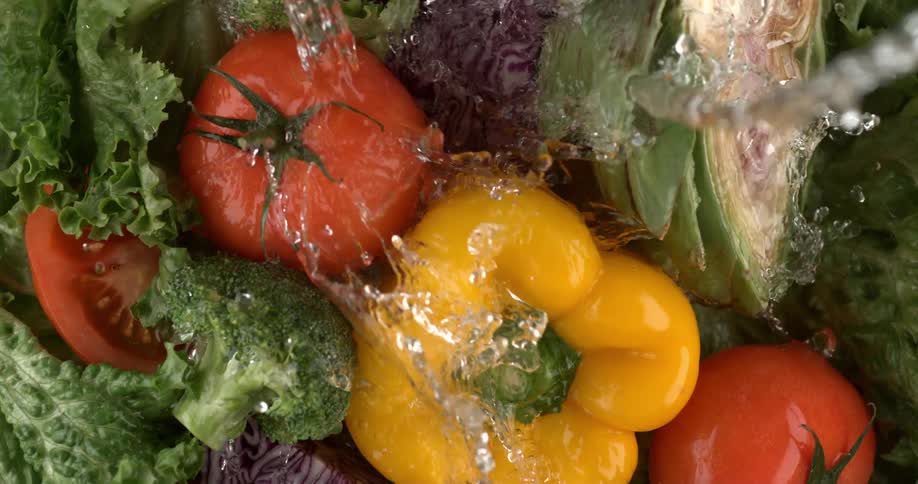 Water washing vegetables on a tray