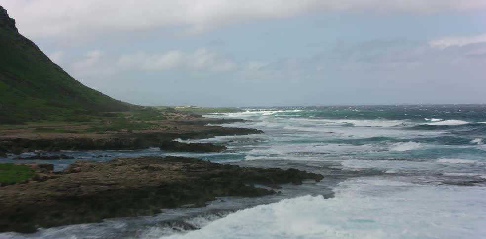 Waves crash onto the shore of a promontory