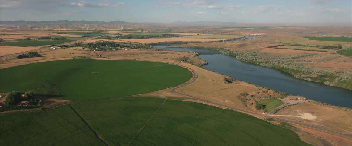 Aerial view of crop circles with a river