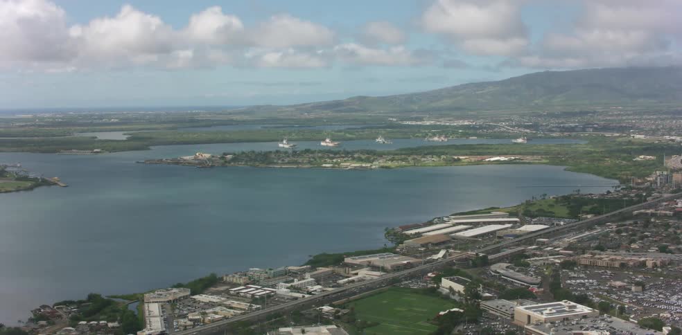 A large town of buildings and roadways beside a lake