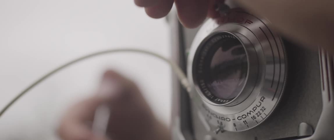 A push button vintage camera being used by a photographer