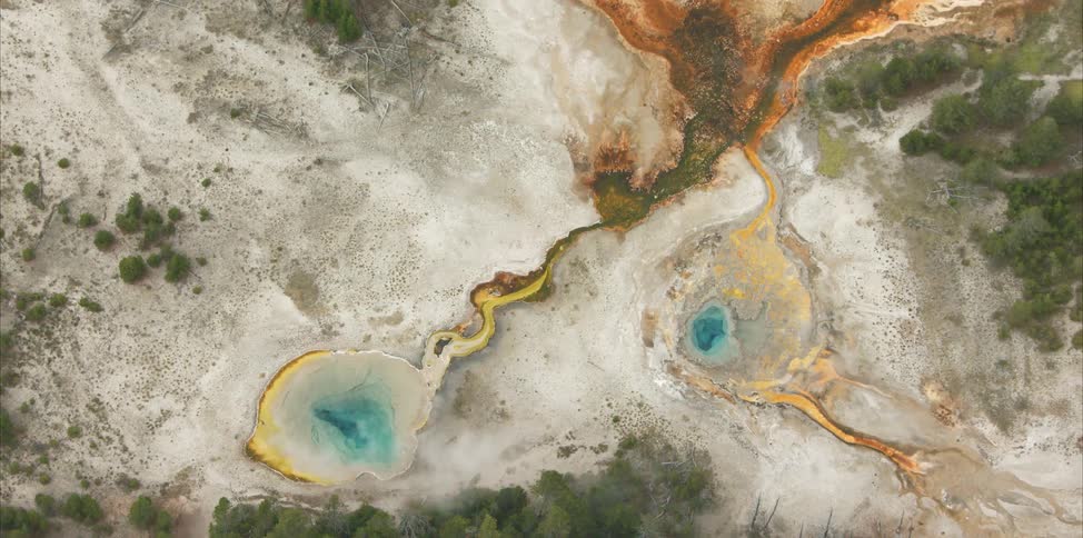 Blue and yellow sulfur pools on a bare landscape
