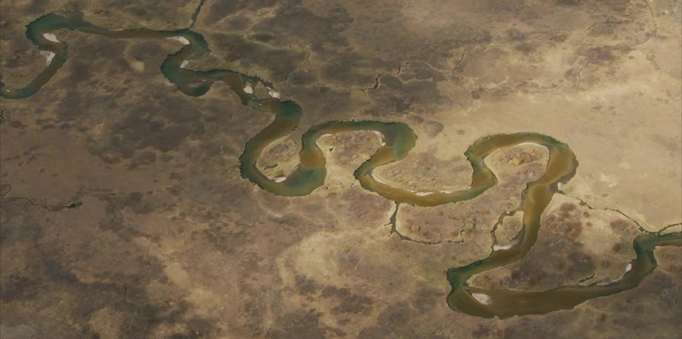 A river snakes through a desert