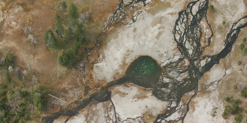 A body of water surrounded by dirt