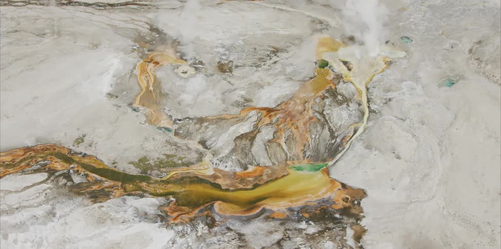 The yellow water streams and moves across the canyon below