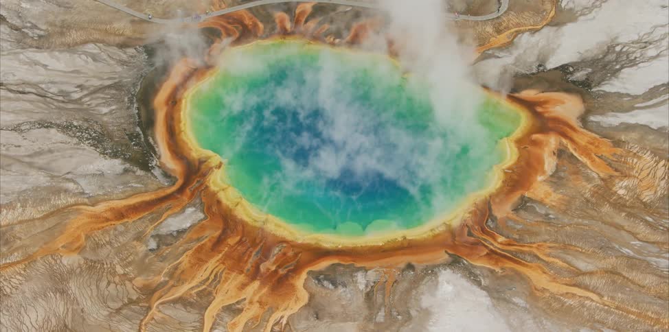 A colorful hot spring in a rock landscape