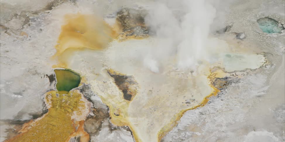 Steam rises from sulfurous geothermal pool