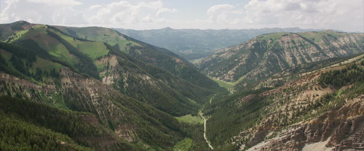 Aerial view of grassy mountain valley in the daytime