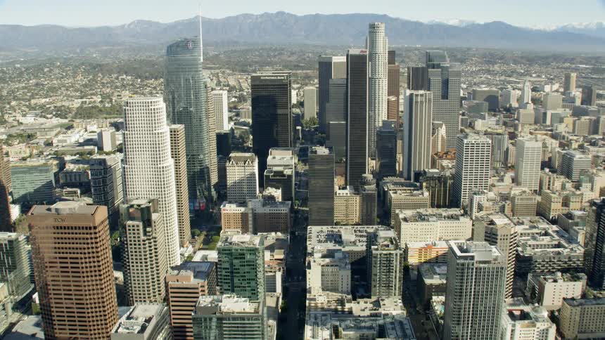 Aerial approach of DTLA with mountain backdrop
