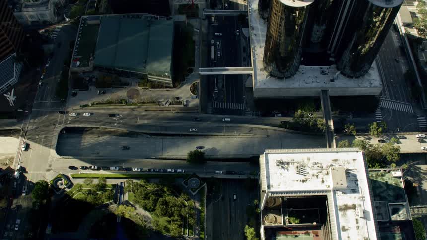 Traffic moves through a downtown area of a city