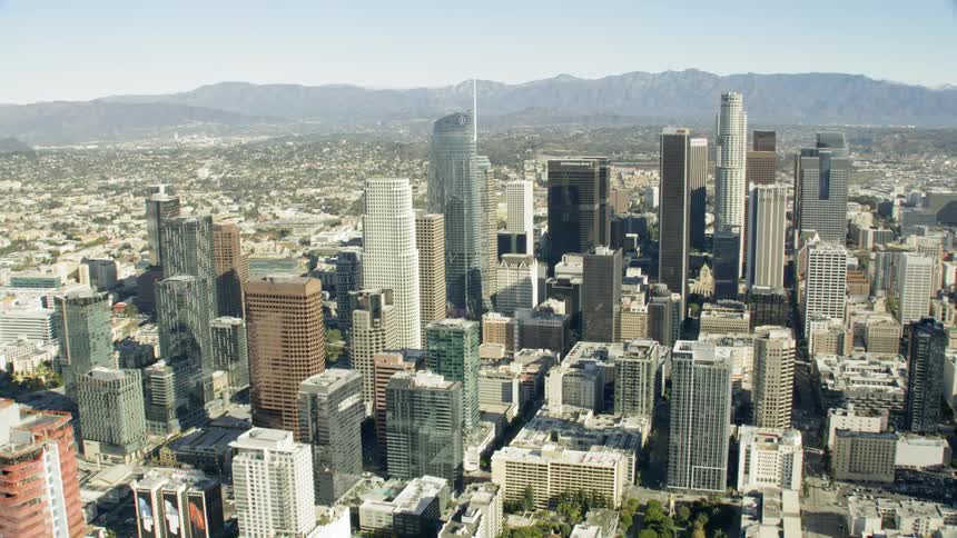 A view of downtown Los Angeles with snowy mountain backdrop