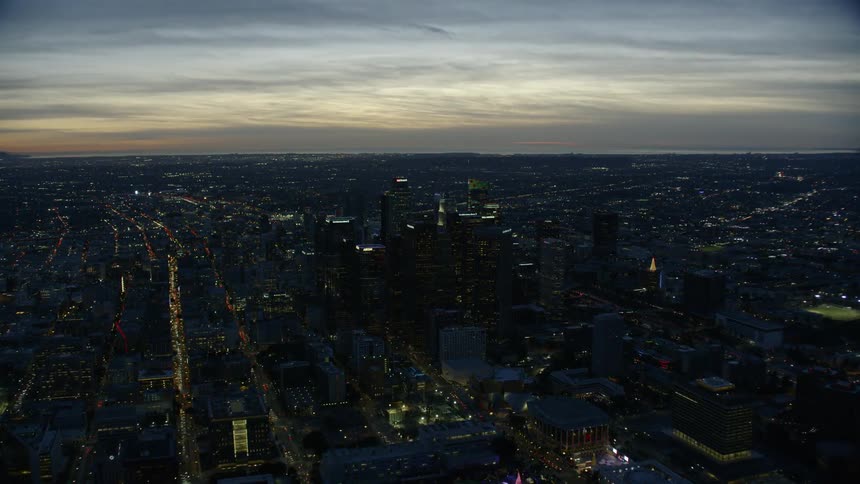 Aerial view of Downtown Los Angeles (DTLA) at dusk with ocean backdrop