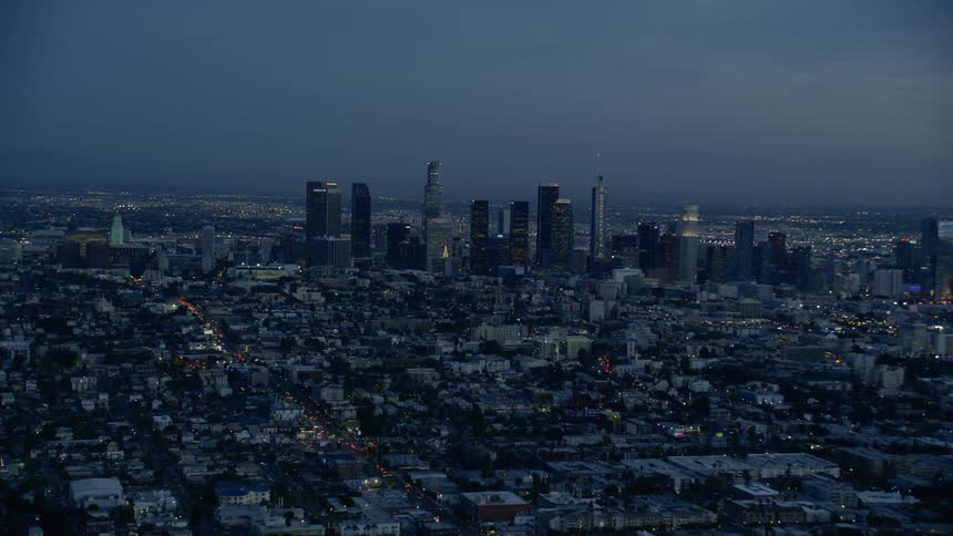 Skyline of the illuminated city with tall buildings and skyscrapers at dusk