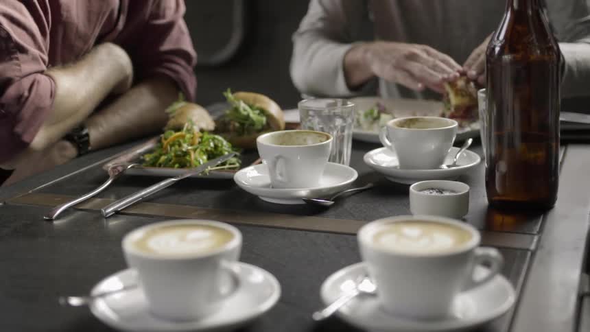 People sitting at a table drinking and eating