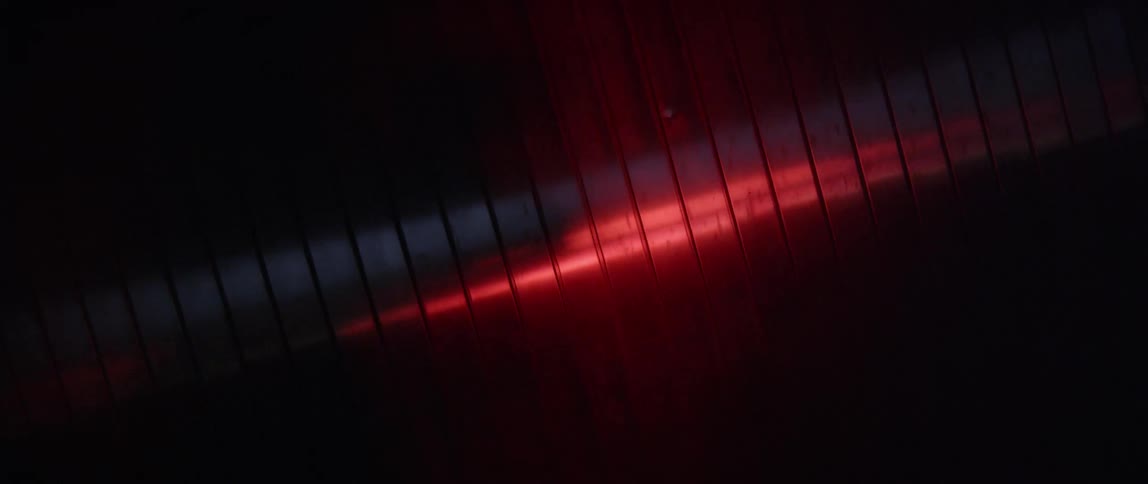 An overhead light fades in and out from red