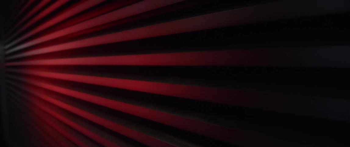 Spotlight highlights red painted slats on wall
