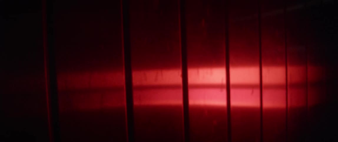 Overhead ceiling lights fade from red to black