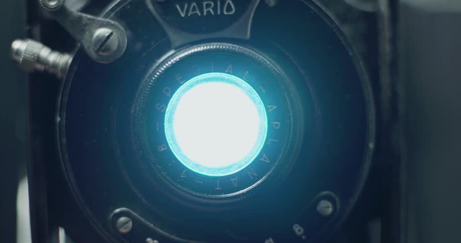 A bright light flashes in an old fashioned camera