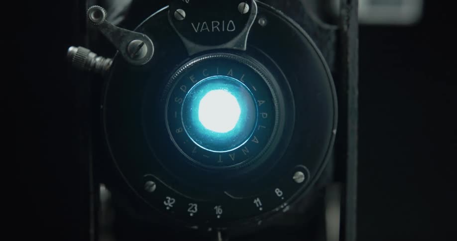 A person flipping a switch on a device to turn on a blue light