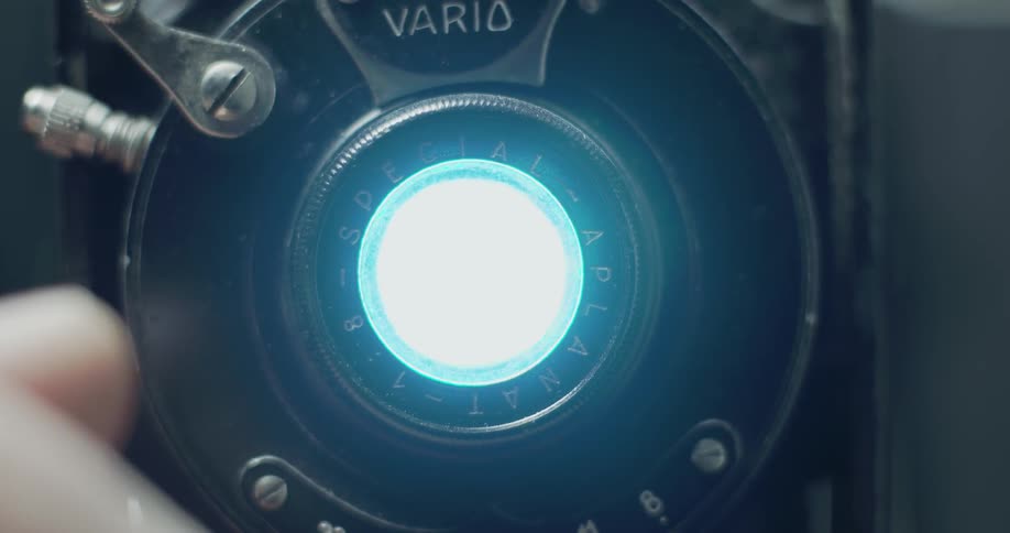 A light shines out of a vintage camera