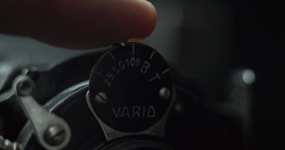A person turns the knob on the machine