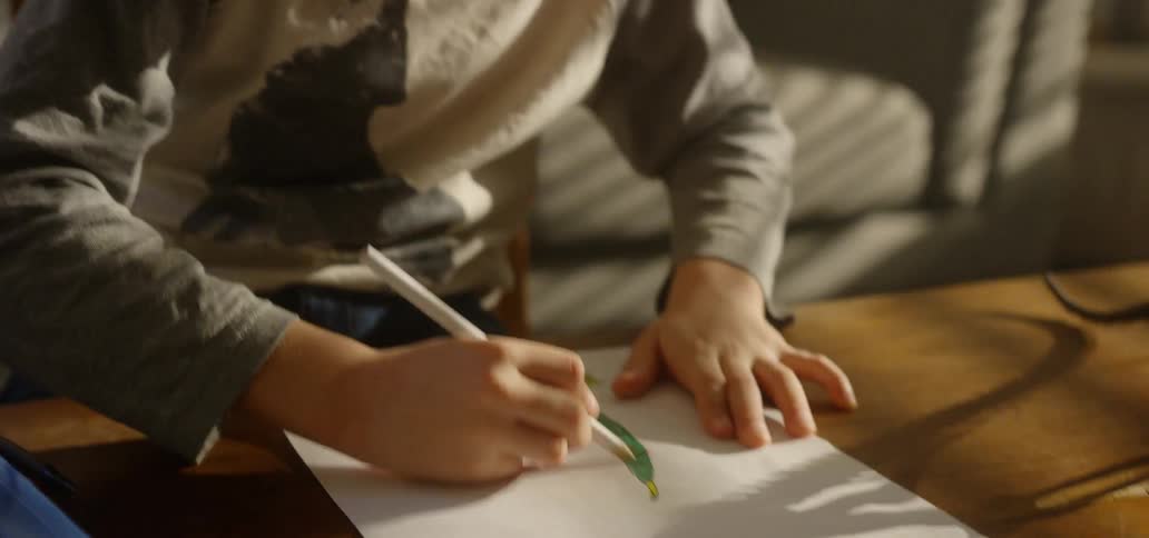 A child colors in a drawing