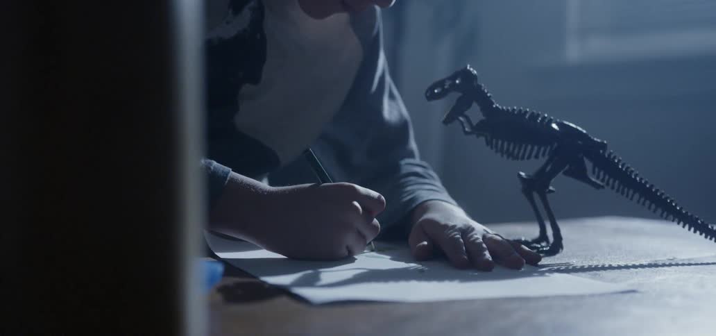 A child is drawing at night