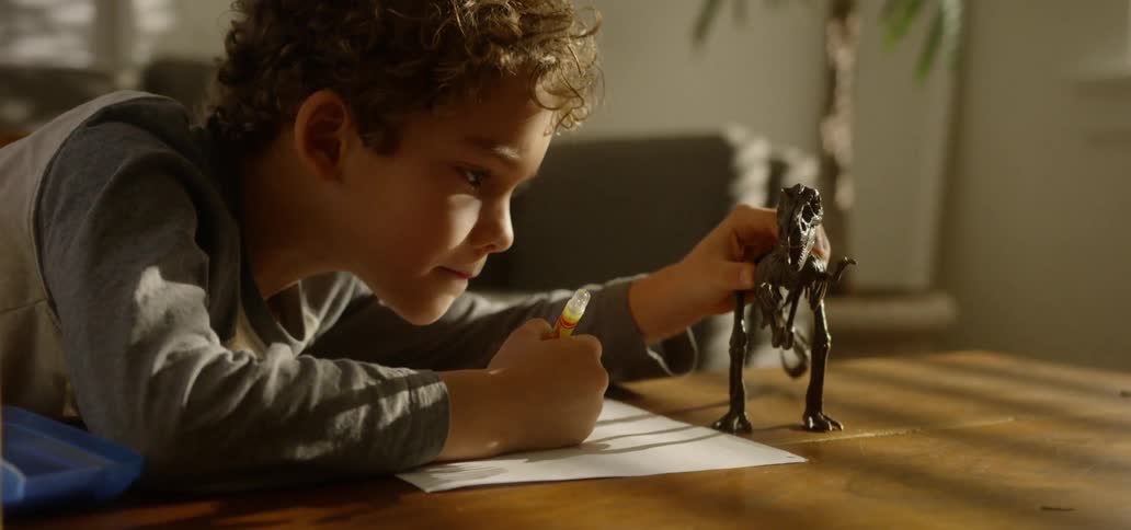 A child plays with a dinosaur skeleton figure
