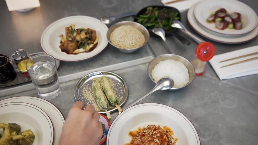 An overhead view of plates of food being eaten at a restaurant