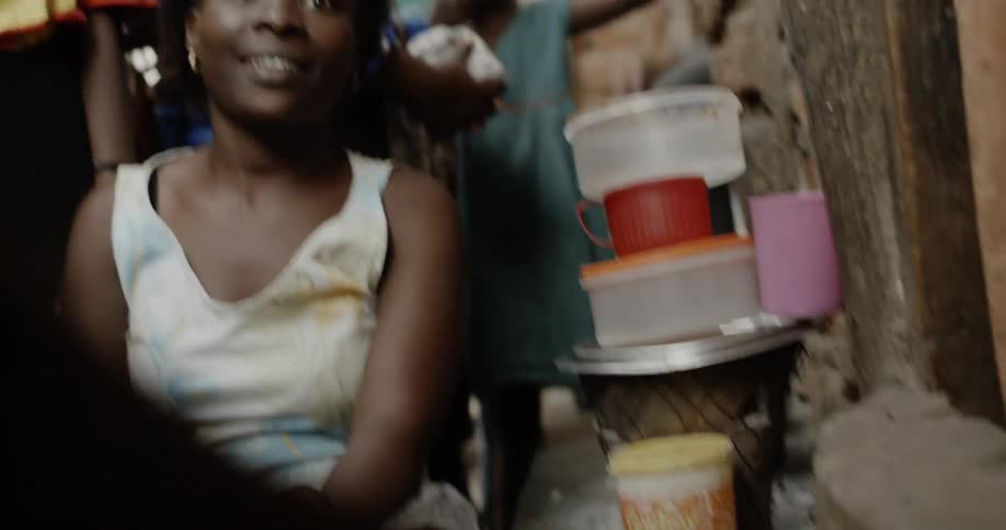 People watching as a person watches clothing in plastic tub